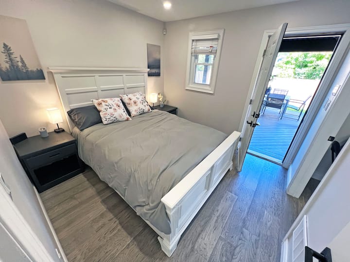 Main floor in-law suite offers comfort and privacy with a queen-size Tempurpedic bed and separate access. Ideal for guests or extended stays, this cozy retreat ensures convenience and a restful night’s sleep.