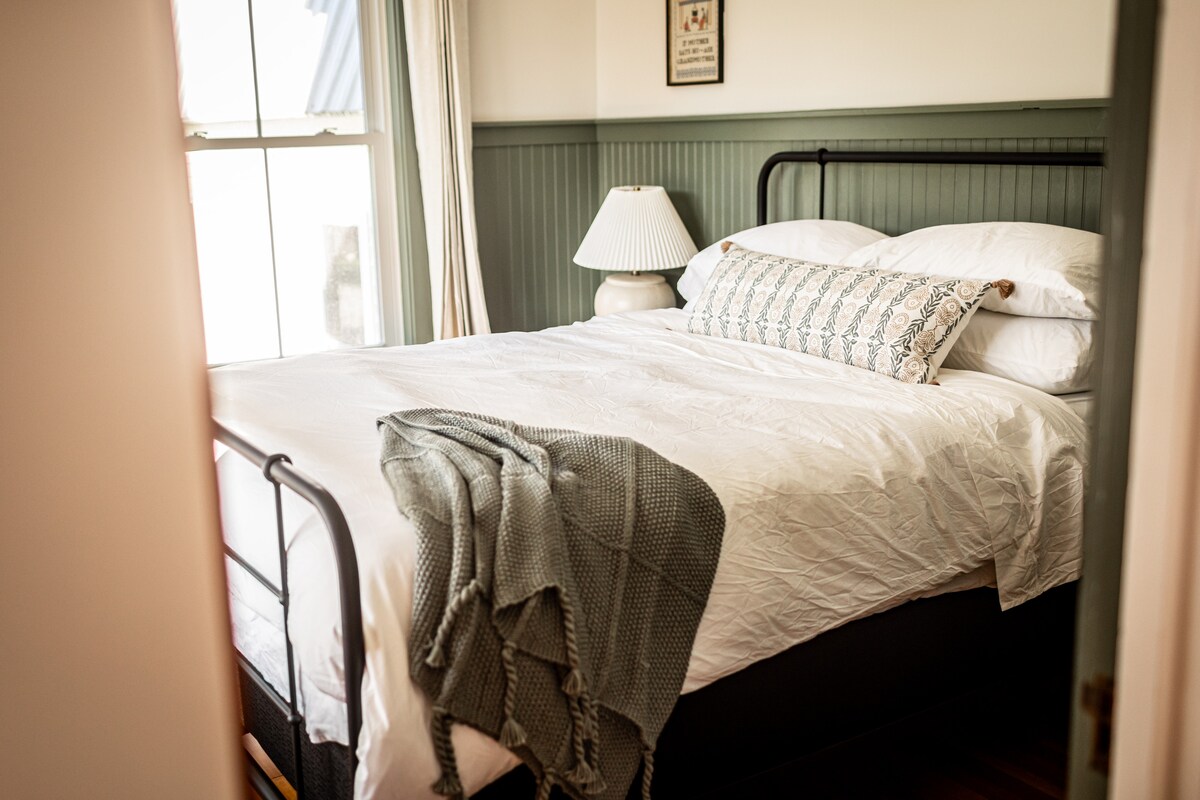 Dormitorio 1 o "Suite de agricultores", cama queen. Las cuatro habitaciones están cuidadosamente equipadas con comodidades para una gran noche de colchones de espuma con memoria de sueño, sábanas de algodón 100% y cortinas opacas. 