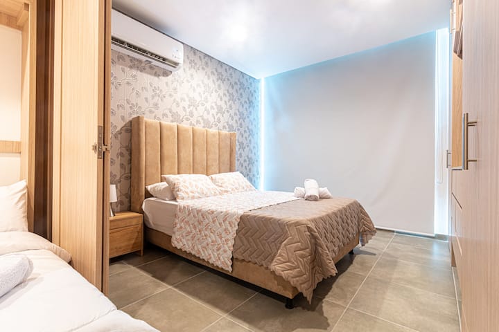 ห้องหลักมีเตียงขนาดใหญ่เครื่องปรับอากาศและสีดำที่หน้าต่างเพื่อนอนดึก 