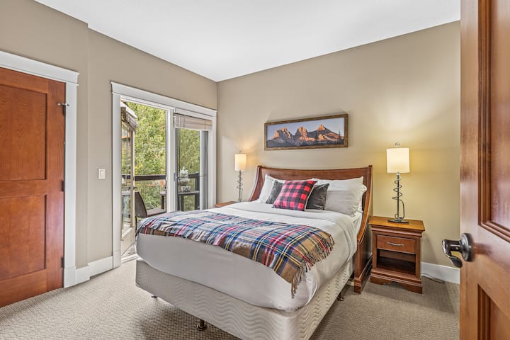 The Second bedroom with a Queen Bed and Balcony with Courtyard views and access to the main bathroom which can be locked off to make it an ensuite. 