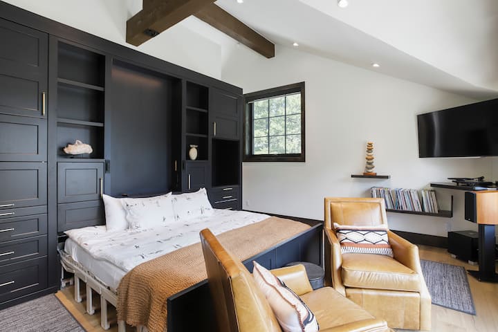 ห้องสวีทเตียงคิงไซส์ชั้นบนมีระเบียงขนาดใหญ่มองเห็นชนบทและภูเขาอ่างอาบน้ำหรูหราพร้อมฝักบัวอาบน้ำและโต๊ะเครื่องแป้งคู่ตู้เสื้อผ้าแบบวอล์คอินและพื้นที่ทำงานพร้อมโต๊ะทำงานวอลนัทสีดำขนาดใหญ่ 