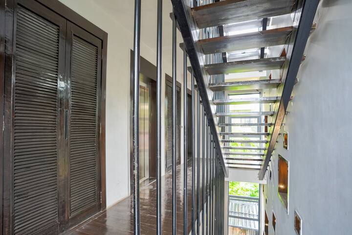Lobby and staircase with view of our elevator