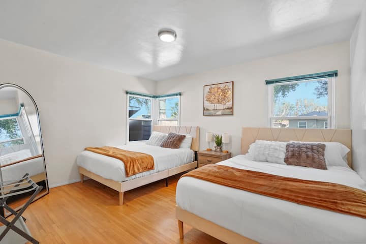 Retire for a good night's sleep in our modern bedroom 2, featuring a giant mirror, 2 queen confortable beds, night stant, accent light and a large closet space.