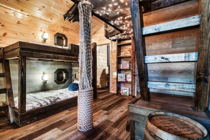 The custom bunk room has a unique feature. Junior pirates can climb the stairs and check out the loft! Filled with a steering wheel and rope railings.