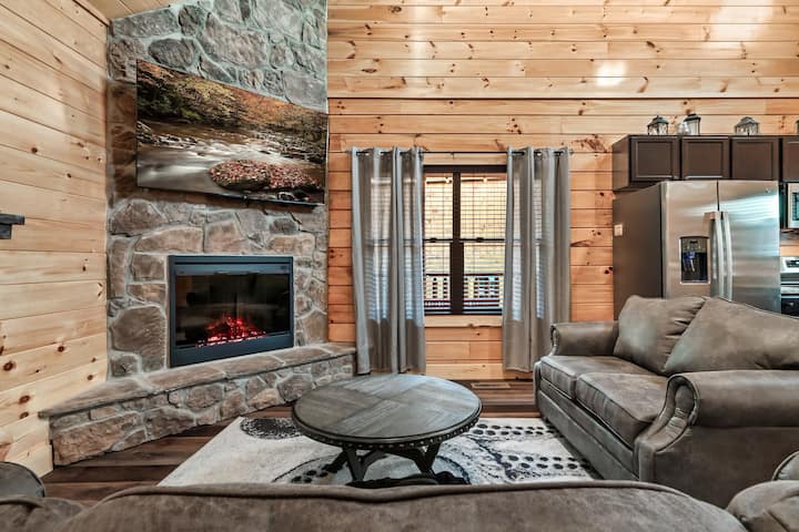 The main living room features a 65" TV, fireplace and a sleeper sofa. It's the perfect spot to relax after a long day exploring the area.