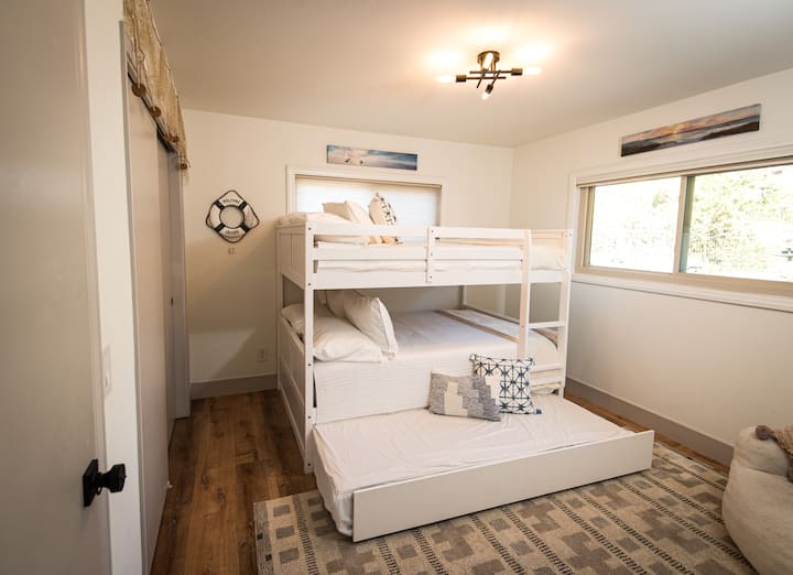 This room has 3 Full Sized beds.  Great for up to 5 or 6 kids.  Or 3 adults or some combination.  The bottom bed is a pullout from under the bunkbeds.