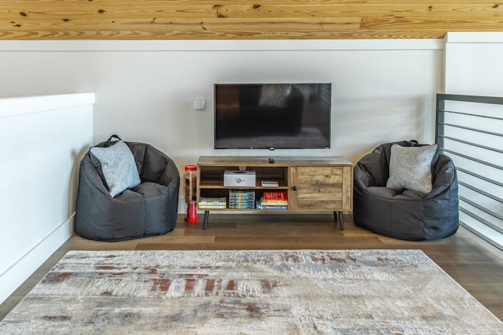 Upstairs loft. This area has a smart TV and a Retro Mini G gaming console with access to thousands of old school video games including Super Mario Brothers, Sonic, and Double Dragon.