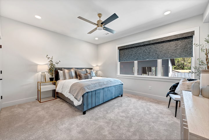 Second floor guest bedroom #1 with king bed, bedside Amazon Alexa to listen to music or set an alarm, satin pillowcases in the beside tables, walk-in closet with extra linens and blackout blinds.