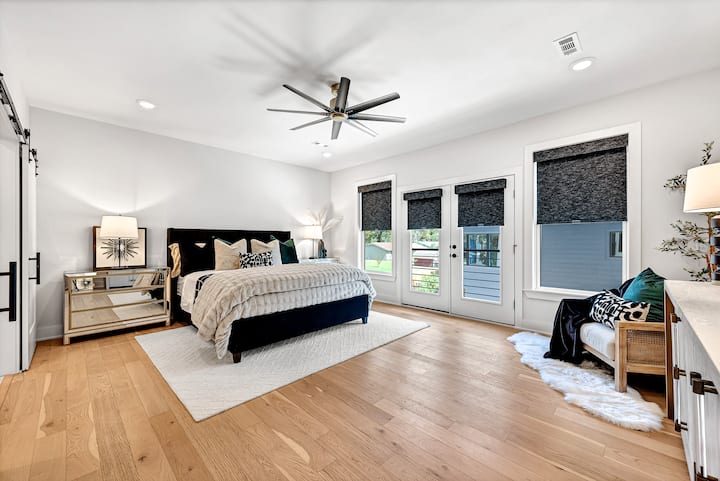 Huge second floor primary suite with California King bed, Juliet balcony, black out blinds, Amazon Alexa free for guests to enjoy music or set an alarm, phone chargers in drawers, satin pillowcases in side tables and an attached bathroom suite.