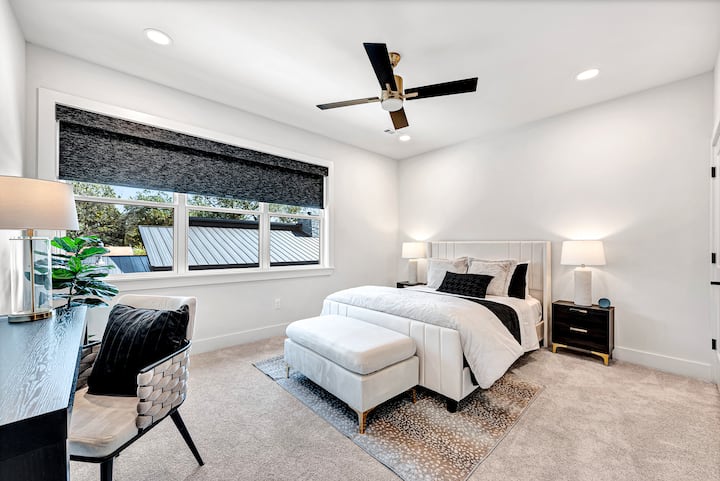 Second floor guest bedroom #1 with queen bed, desk space, bedside Amazon Alexa to listen to music or set an alarm, satin pillowcases in the beside tables, walk-in closet with extra linens and blackout blinds.