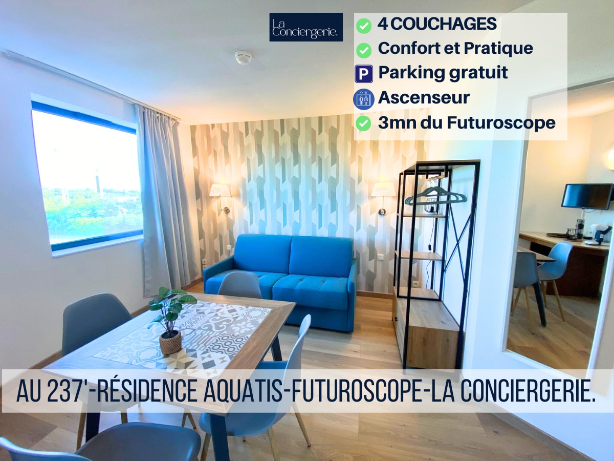 A living area is displayed, featuring a light blue sofa bed and a dining table for four. Natural light is provided by a large window with curtains. The walls are decorated with a subtle patterned design, and neutral wooden flooring enhances the inviting space.