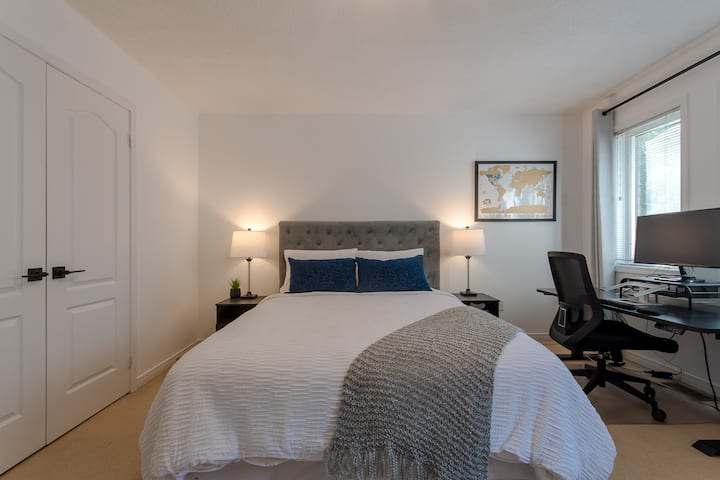 Bedroom 2 of 3 with Queen Bed and full work station with electronic standing desk, laptop stand & large monitor