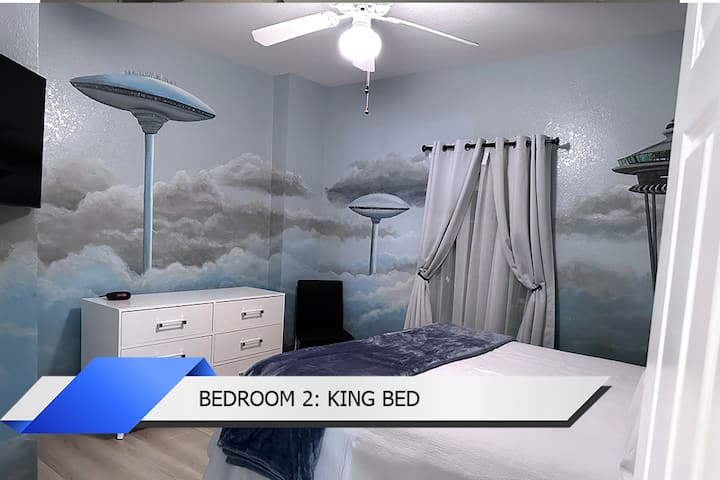 Bedroom 2: King Bed: Dream in style under a Star Wars mural, complete with a comfortable bed.