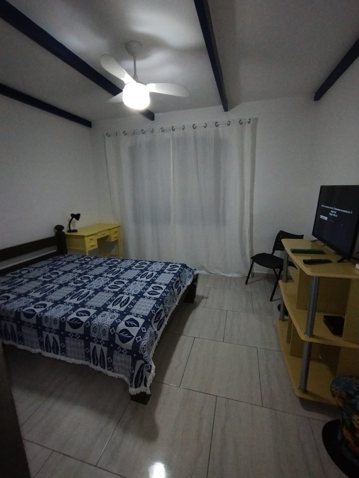 Chumba chenye vitanda viwili na televisheni. 