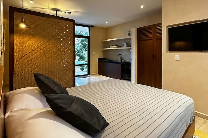 For a cozy movie night, there's a 43"Ultra HD Samsung 4K Ultra HD TV right in front of your bed on the floors.