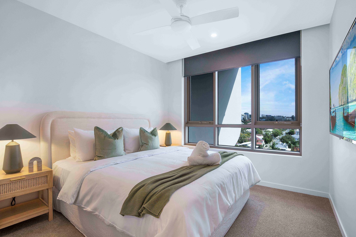 Chumba kikuu cha kulala chenye kitanda aina ya king, bafu la ndani, kabati la kuvaa, feni ya dari na televisheni janja.