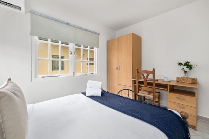 An elegant bedroom with AC unit and bright interior.