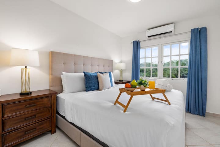 An elegant bedroom with AC unit and bright interior.