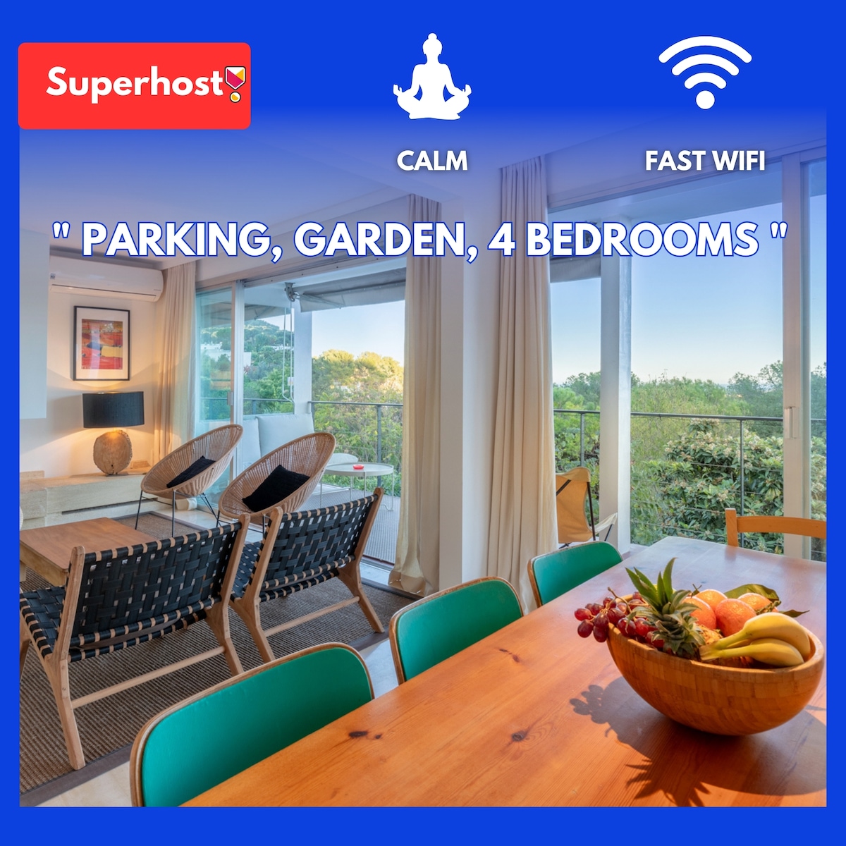 An inviting living space with large windows allowing natural light to fill the room. A dining table is complemented by colorful chairs, and a bowl of fresh fruit is placed centrally. Two stylish chairs are positioned nearby, enhancing the area's comfort.