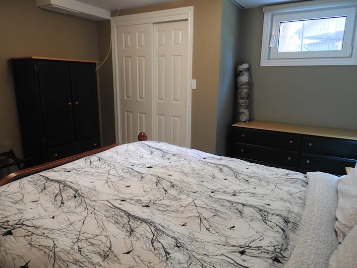 This second bedroom also has a dresser and closet with hangers and two more luxurious bathrobes to use to go outside to the hot tub. The cupboard also has a tv that shows whatever is on the tv in the living area. 