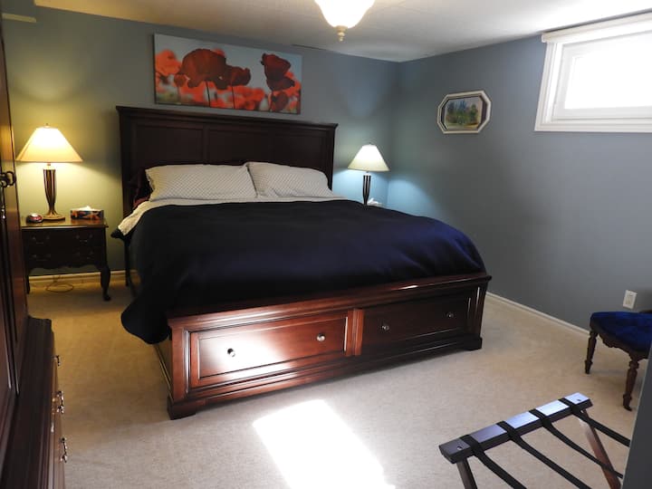 Very comfortable king size bed in this first bedroom that includes a large egress window with blind. 