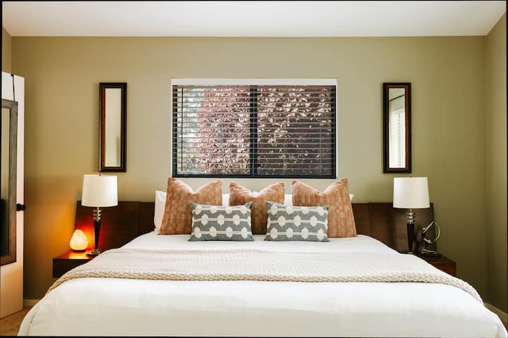 Master Bedroom with Views of Thunder Mountain and Ornamental Plums, ample storage, a long closet with terry cloth robes and a safe, and a TV. Bathroom is ensuite. 