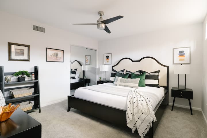 3rd Bedroom Downstairs with ample storage, ceiling fan, and TV. 