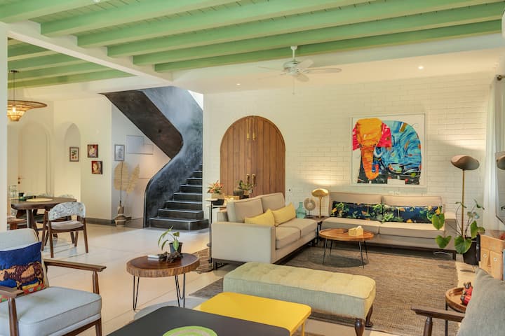 ✨A vibrant, playful haven with lime green beams, eclectic art, and a bold staircase — this living room is a seamless fusion of Goan charm and modern creativity✨