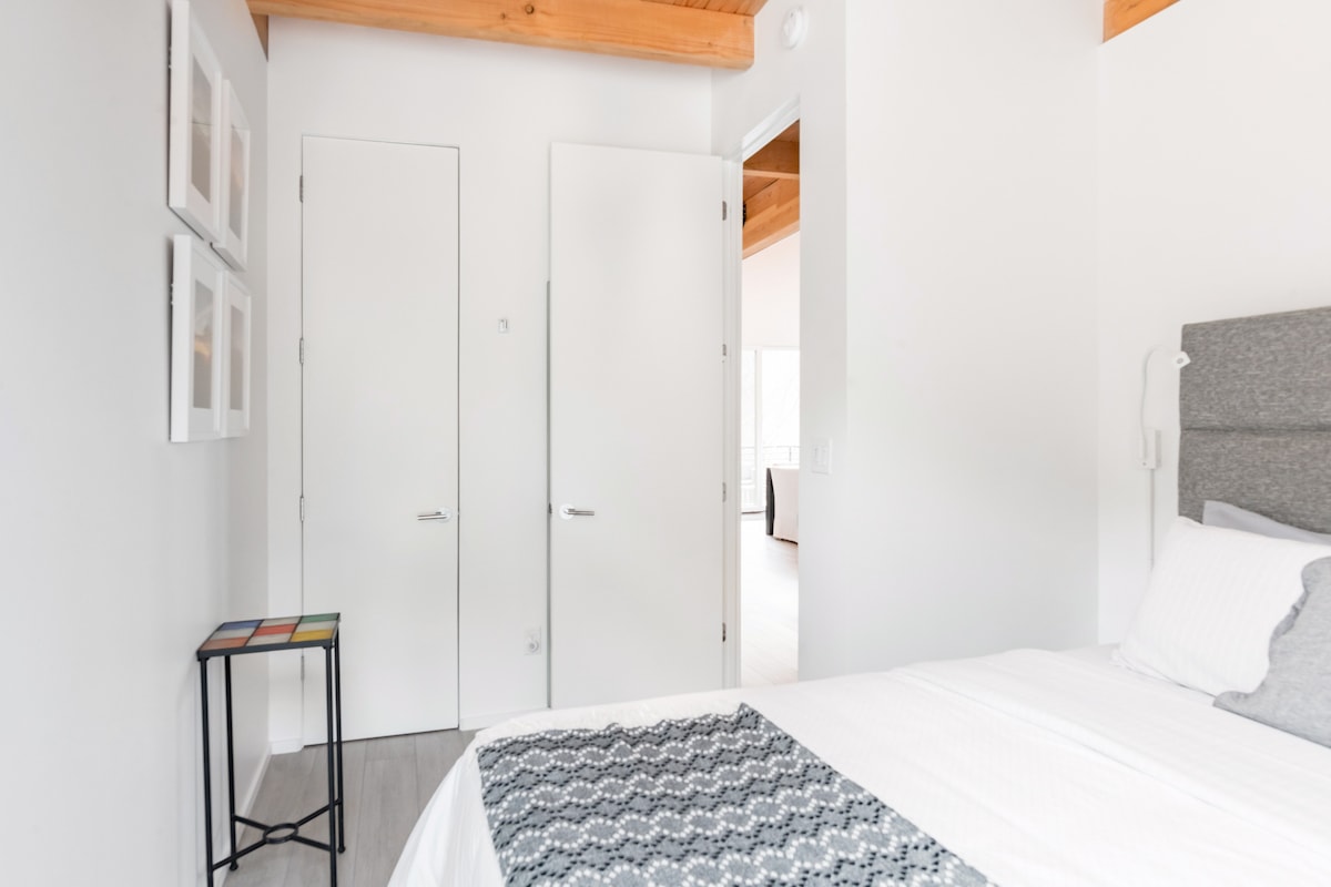 Take a closer look at the bedroom's design from a new angle, highlighting its unique character.