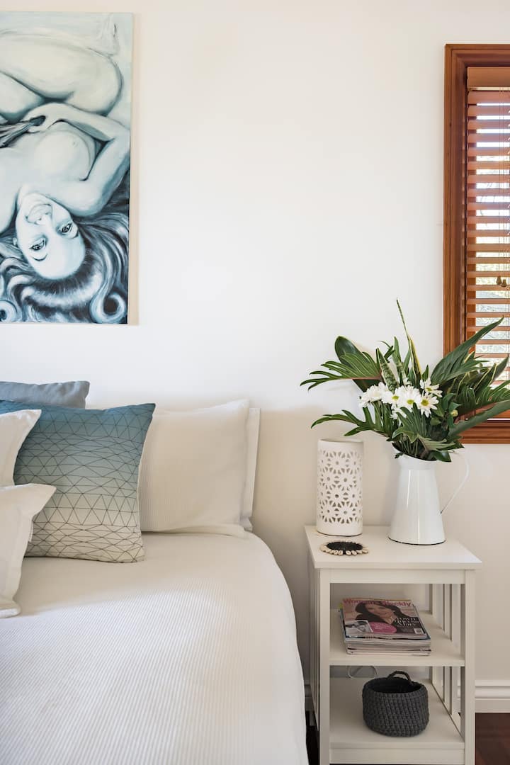 The master bedroom is comfy and beautifully appointed. French doors open onto a deck surrounded by nature and welcome the morning sun!