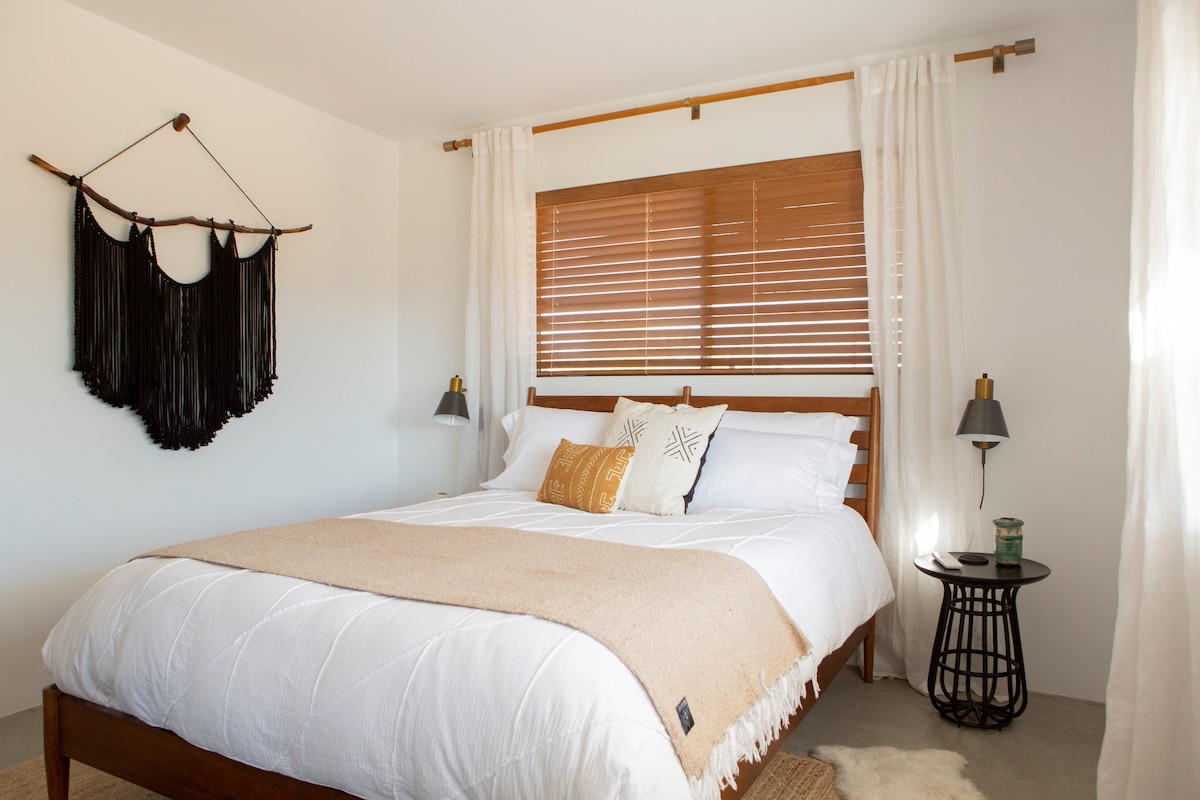 Wake up to sunny views after sleeping comfortably in a Queen-size Tuft & Needle memory foam mattress.