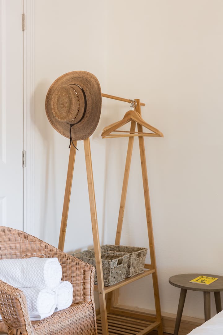 Bamboo clothes rack with hangers and fresh spa bath towels