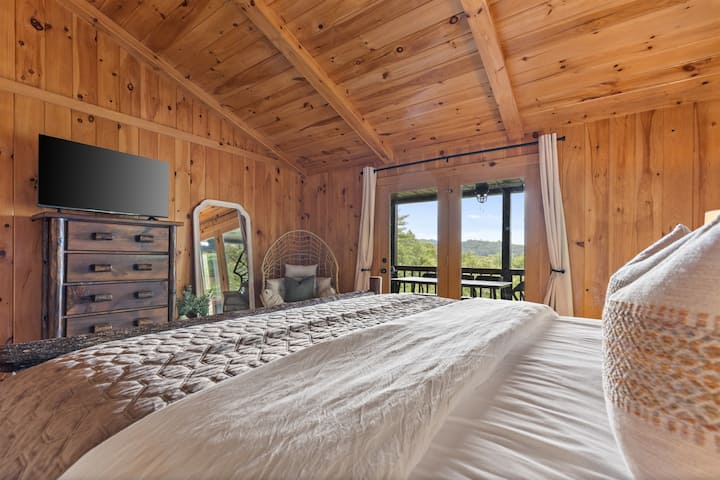 Wake up to breathtaking views in the main-level master bedroom. Sip your morning coffee or enjoy breakfast in bed while soaking in the serene scenery right from your window.