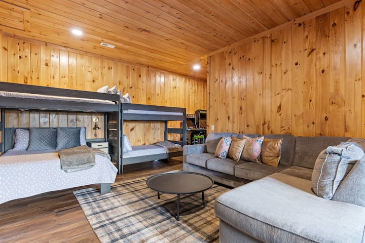 Family‑friendly lower‑level game room with bunks, arcade games, shuffleboard, and a second living area. The perfect spot for all‑ages fun, rain or shine in this Blue Ridge cabin.