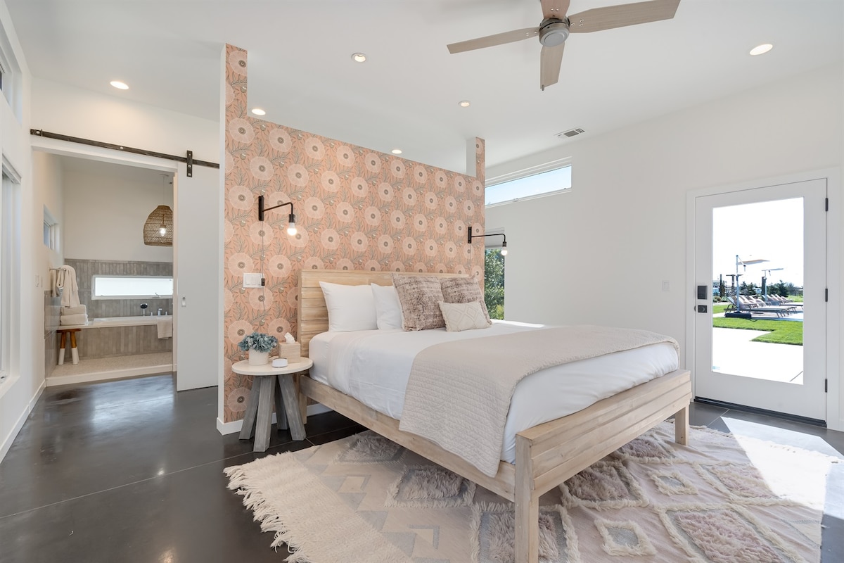 Primary Bedroom: Bright and airy retreat with modern decor and direct access and serene outdoor views.