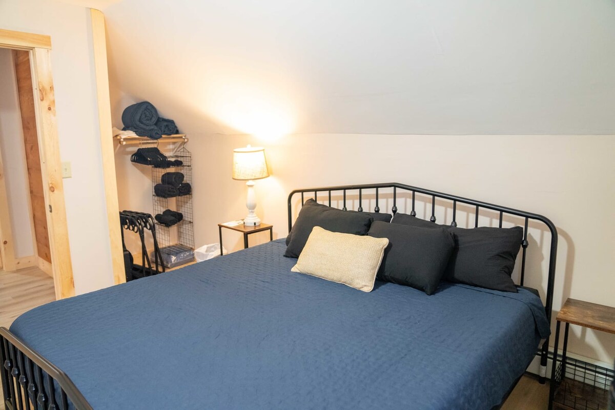 Bedroom 2 has a king-sized bed, bedside tables + lamp