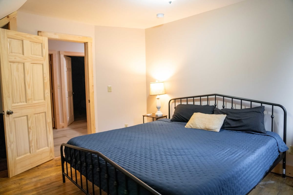 Bedroom 1 has a king-sized bed, bedside tables, lamp + closet