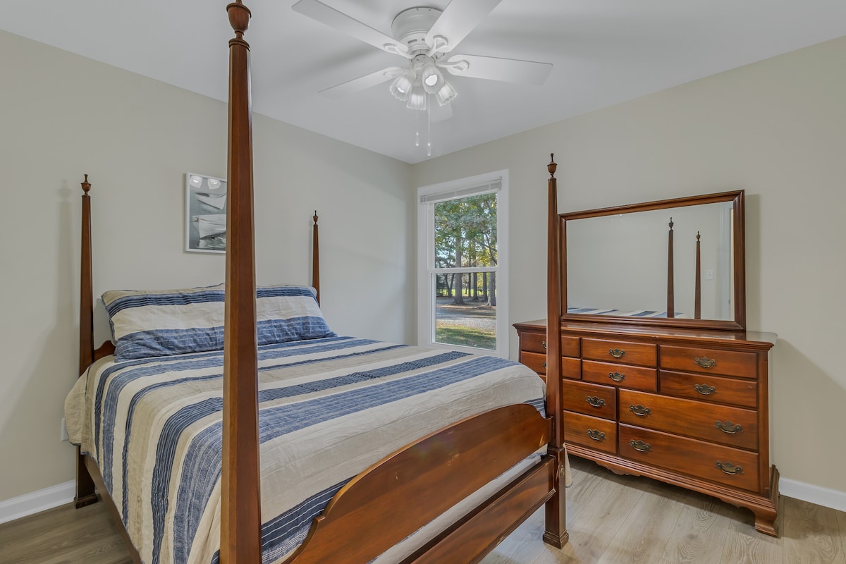 Chambre avec lit double et vue sur la cour avant.