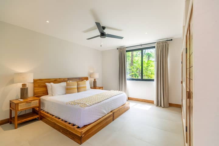 Disfruta de una comodidad incomparable en el dormitorio principal en. Este amplio refugio cuenta con una decoración sofisticada, una cama suntuosa y acceso directo al aire libre, lo que garantiza una estancia relajante y lujosa en medio de un entorno sereno.