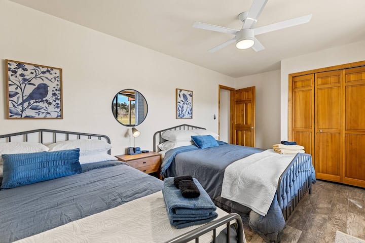 Downstairs/ basement bedroom #1, two queen beds, bedside charging and closet space. 