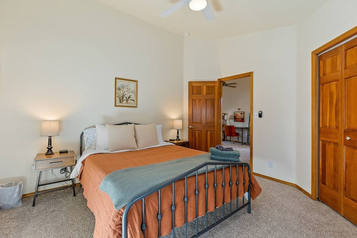 Upstairs bedroom #1 with a queen bed, bedside charging and closet space. 