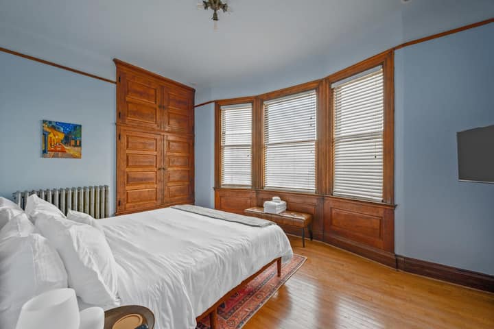 Acogedor en este dormitorio bellamente diseñado con impresionantes paneles de madera y una cama blanca nítida. ✨ #roomgoals #interiordesign #cozyvibes Bedroom #4 - King Bed