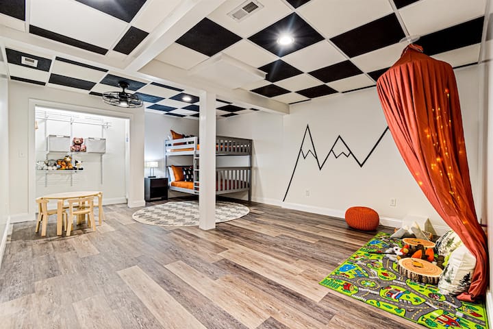 L’area per bambini al piano inferiore dispone di un letto a castello a grandezza naturale, un soffitto a quadretti, un tavolo da gioco, una tettoia per la lettura con luci e un armadio pieno di giocattoli. C’è una porta per isolarlo all’ora di andare a dormire.
