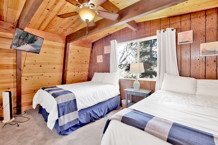 Peaceful cabin bedroom with plush bedding, and beautiful views—ideal for restful nights, cozy mornings, and a relaxing mountain escape.