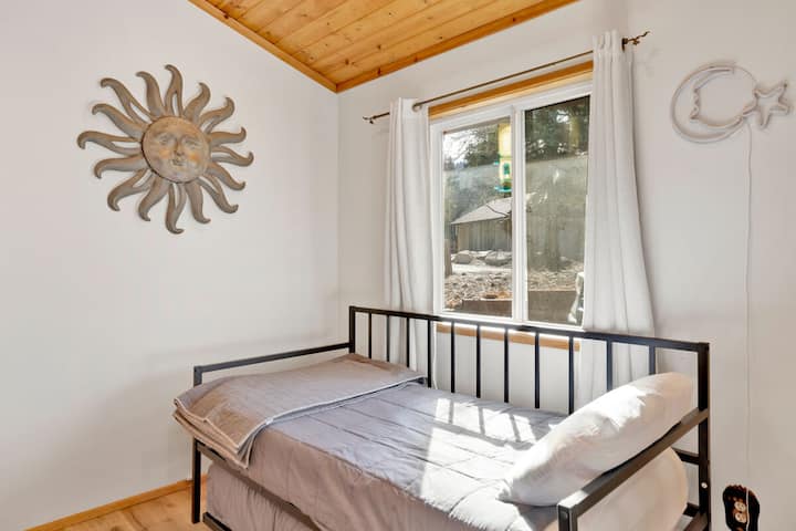 Peaceful cabin bedroom with plush bedding, and beautiful views—ideal for restful nights, cozy mornings, and a relaxing mountain escape.