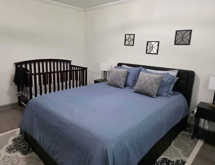Comfortable queen bed and crib, perfect for families