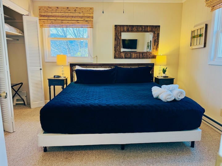 Our main floor King bedroom has a King bed, 2 nightstands, outlets with USB ports, luggage racks, hangers, a chair, Roku Smart TV. You'll be the closest to the coffee maker in the morning! ;)