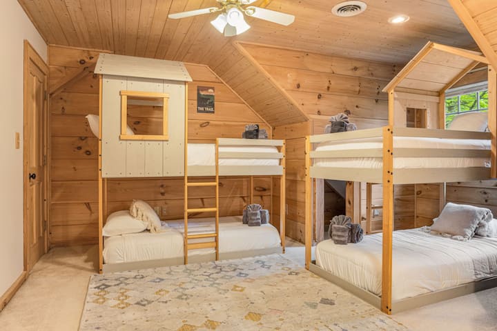 Um espaço projetado para a diversão! Este quarto infantil dispõe de beliches, um banheiro privativo aconchegante e um esconderijo secreto para brincadeiras sem fim.