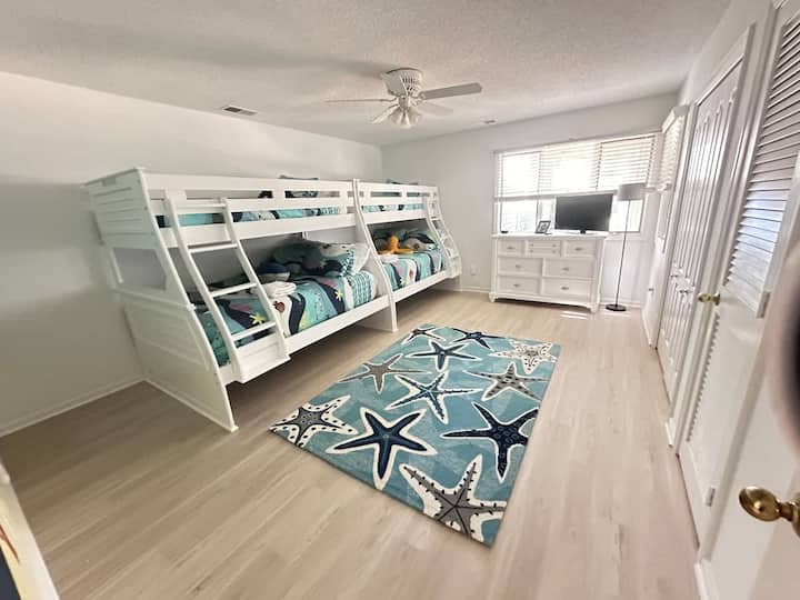 This bedroom is on the first floor.  It has two twin over full bunk beds.   It shares a bathroom with the other room on the first floor.   The TV is a Roku with YouTube TV access for live sports, shows, and news.