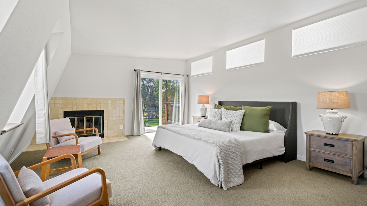 Master bedroom with deck access, fire place, closet space and adjoining master bath